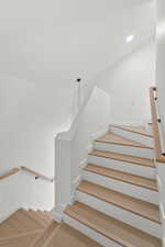 Stairs with recessed lighting and wood finished floors
