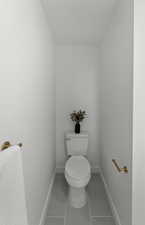 Bathroom featuring toilet and light tile patterned floors