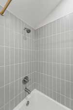 Full bath featuring shower / bathtub combination and a textured ceiling