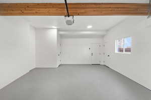 Garage with recessed lighting and a garage door opener