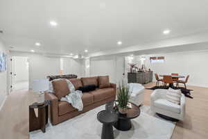 Living area featuring light wood-style floors and recessed lighting