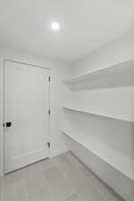 Mudroom with light tile patterned floors and recessed lighting
