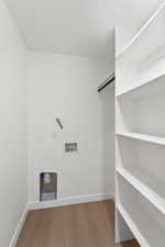 Laundry area with hookup for a washing machine and light wood-type flooring