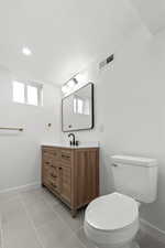 Bathroom featuring vanity, a textured ceiling, and light tile patterned floors