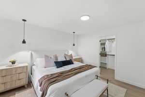 Bedroom with light wood finished floors and baseboards