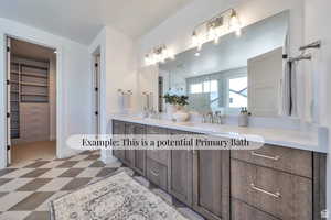 Bathroom with light floors, double vanity, a marble finish shower, and a spacious closet