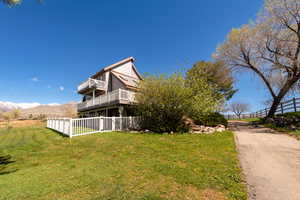 View of side of home with a deck with mountain view