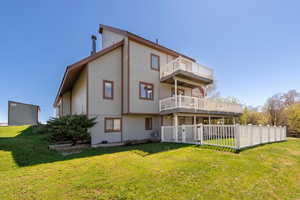 Back of house with a balcony