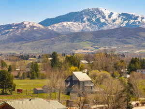 View of mountain backdrop featuring rural landscape