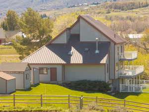 View of front facade featuring a storage unit, a metal roof, and a view of rural / pastoral area
