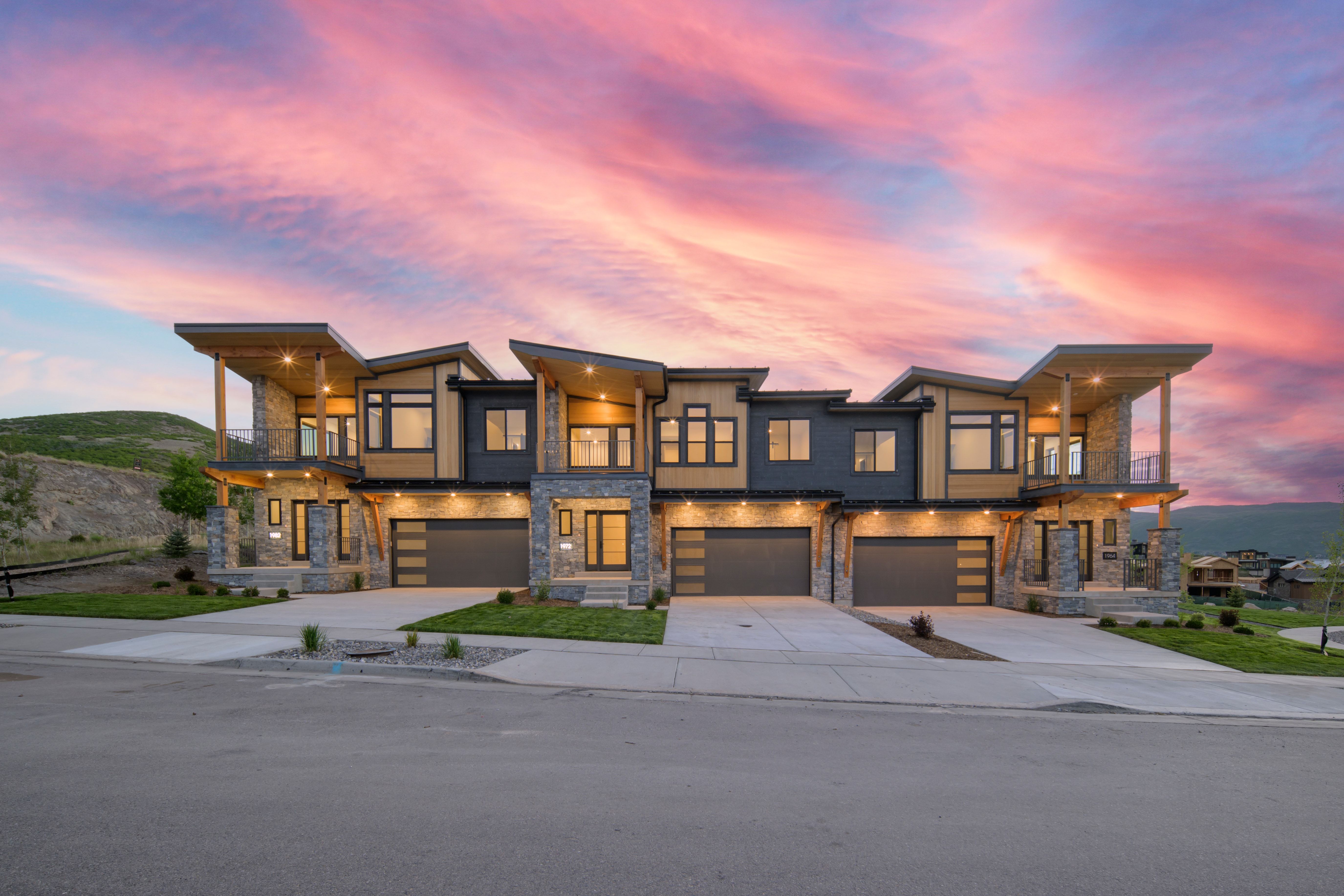 Modern townhome architecture featuring stone and wood-look siding