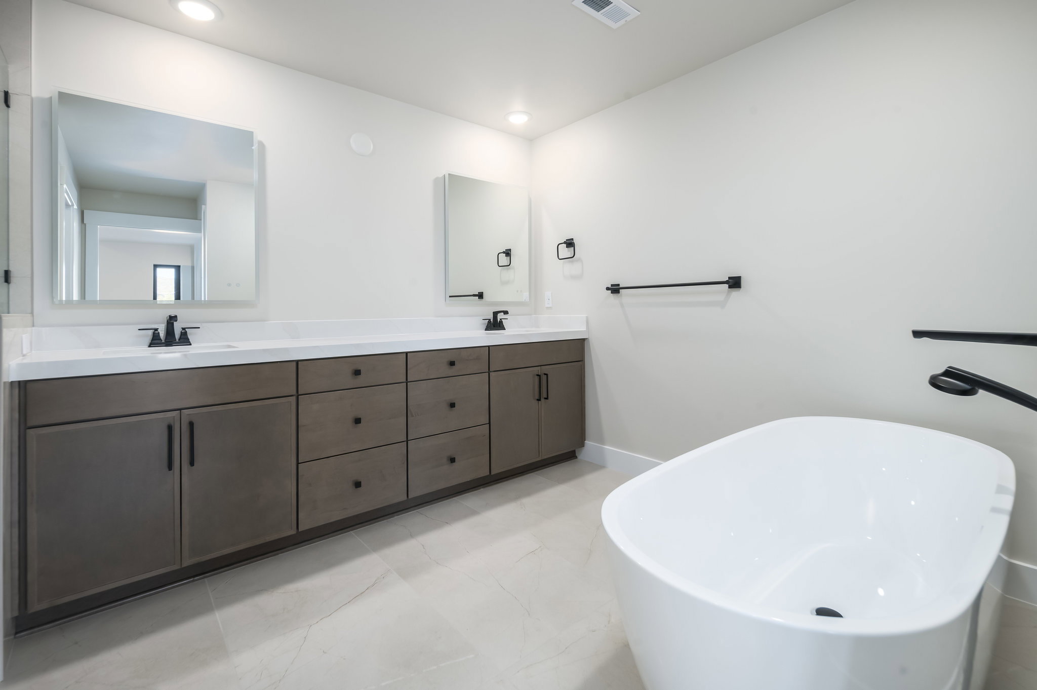 Bathroom featuring double vanity and a freestanding bath