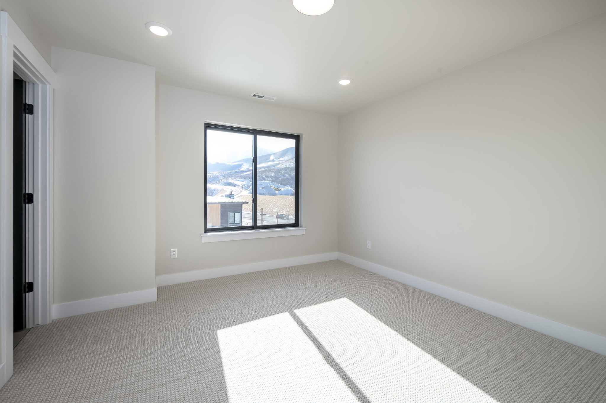 Unfurnished room with light colored carpet and recessed lighting