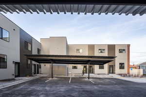View of building exterior with covered parking