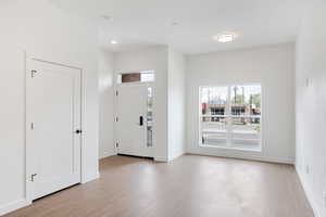 Foyer with plenty of natural light, light wood-style floors, and recessed lighting