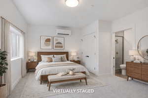 Bedroom with light carpet, a closet, and ensuite bath