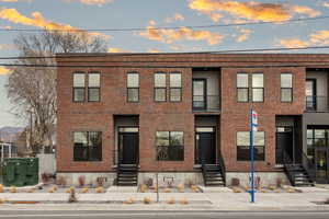 Traditional-style home featuring brick siding and a balcony