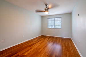 Spare room with light wood finished floors and a ceiling fan
