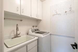 Laundry room featuring cabinet space and hookup for a washing machine