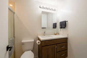 Full bath with vanity and a shower stall