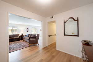 Living room featuring light wood-style flooring and recessed lighting