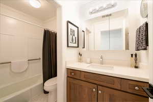 Bathroom with crown molding, vanity, and shower / bath combo