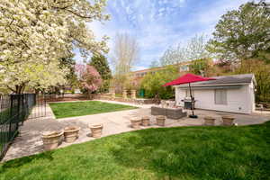 View of yard with a patio area and an outdoor living space with a fire pit