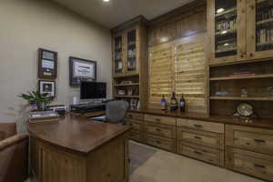 Home office featuring light carpet