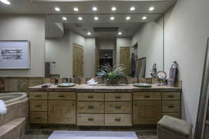 Full bath featuring double vanity, a bath, and recessed lighting