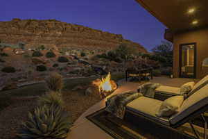 View of patio / terrace with a mountain view, an outdoor fire pit, and outdoor dining space