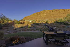 View of patio with outdoor dining area, an outdoor fire pit, and a mountain view