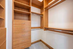 Custom closet system featuring light wood-finish cabinetry