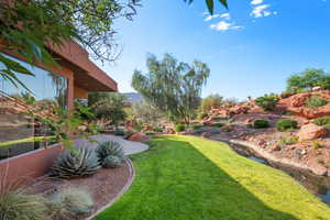 Expansive green lawn bordering a natural water feature