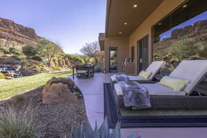 View of patio with outdoor dining area and a mountain view