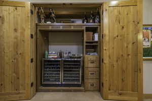 Bar area with carpet flooring and wine cooler