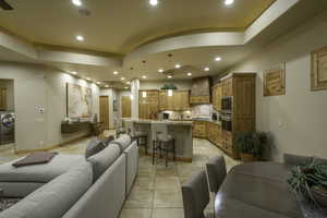 Living area featuring washer / clothes dryer, recessed lighting, light tile patterned floors, and ceiling fan