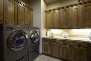 Laundry room with independent washer and dryer and cabinet space