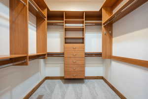 Custom closet system featuring natural wood-finish cabinetry