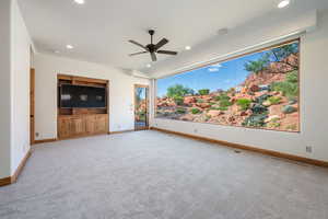 Expansive picture window showcasing a natural rock landscape and water feature
