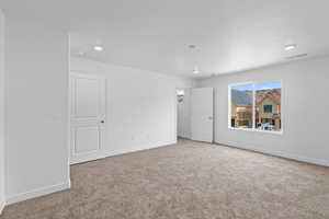 Unfurnished bedroom with baseboards and carpet floors