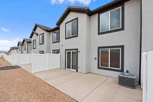 Rear view of property featuring stucco siding, a residential view, and a patio area