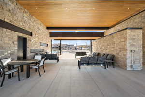 View of patio featuring an outdoor living / dining area and exterior fireplace