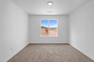 Empty room with carpet flooring and baseboards