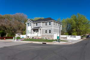 View of front of property featuring stone siding, a garage, board and batten siding, and driveway