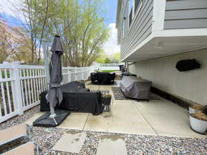 Fenced backyard with a patio and grilling area
