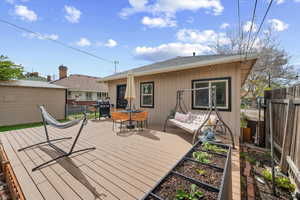 Wooden deck featuring grilling area and outdoor furniture