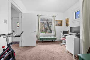 Office area featuring light carpet