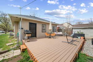 Deck featuring area for grilling and outdoor dining area