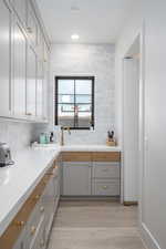 Laundry area with light wood-style floors