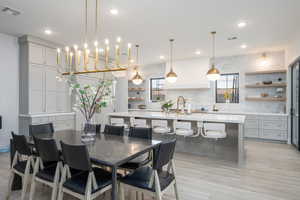 Dining area with light wood-style flooring, healthy amount of natural light, and recessed lighting